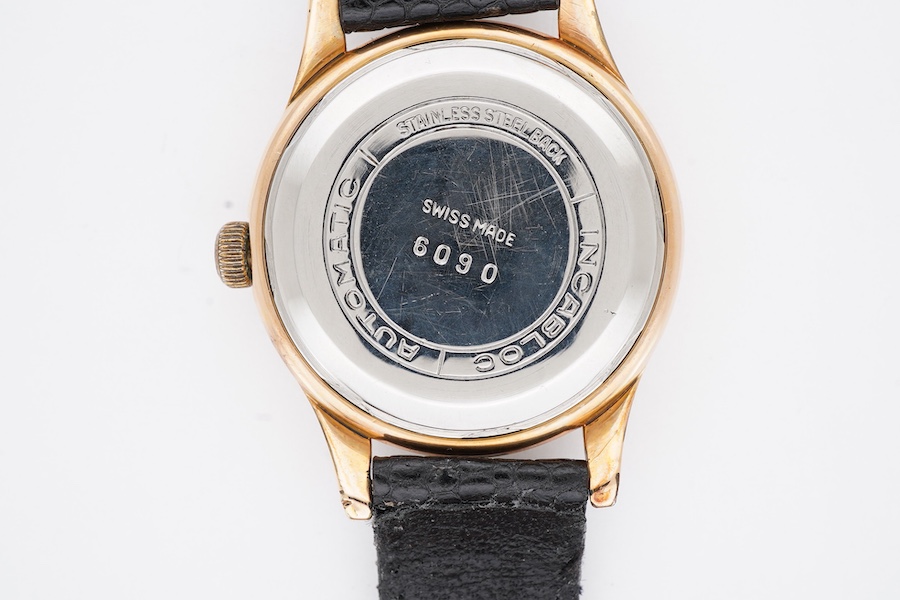 A gentleman's steel and gold plated Bucherer automatic wrist watch, with baton and quarterly Arabic numerals, case diameter 34mm, on an associated leather strap.